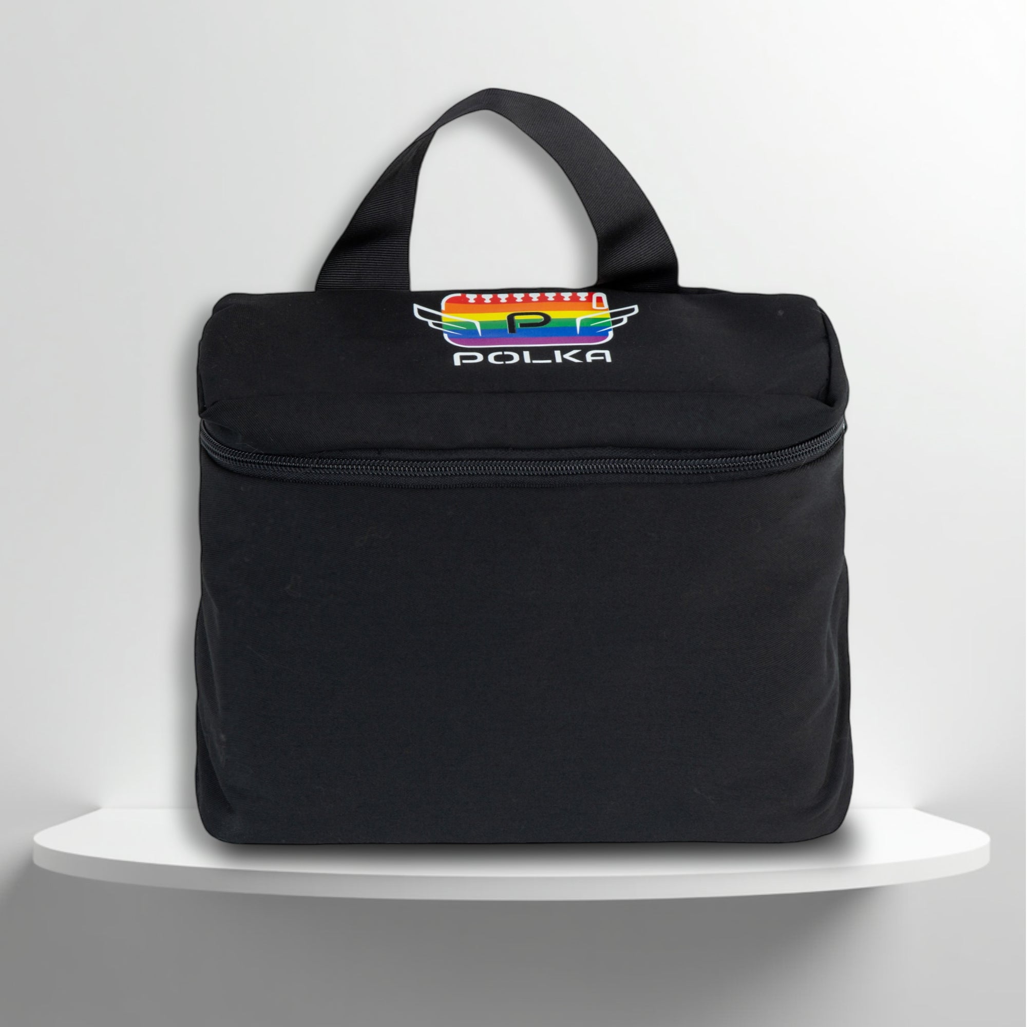 A black cotton travel vanity bag with many Greek travel size personal hygiene products inside for the LGBTQ+ community 