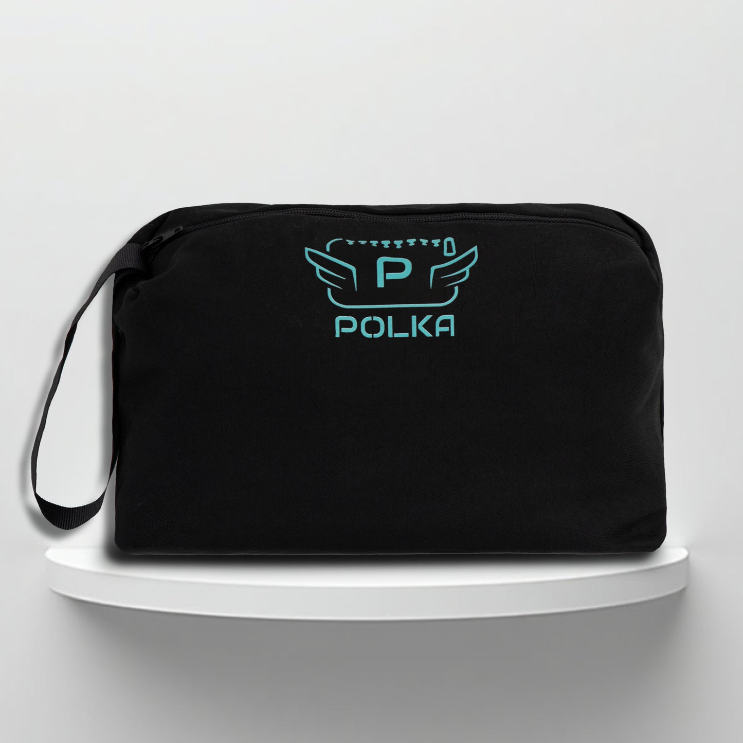 A black cotton travel vanity bag with many Greek travel size personal hygiene products inside for men