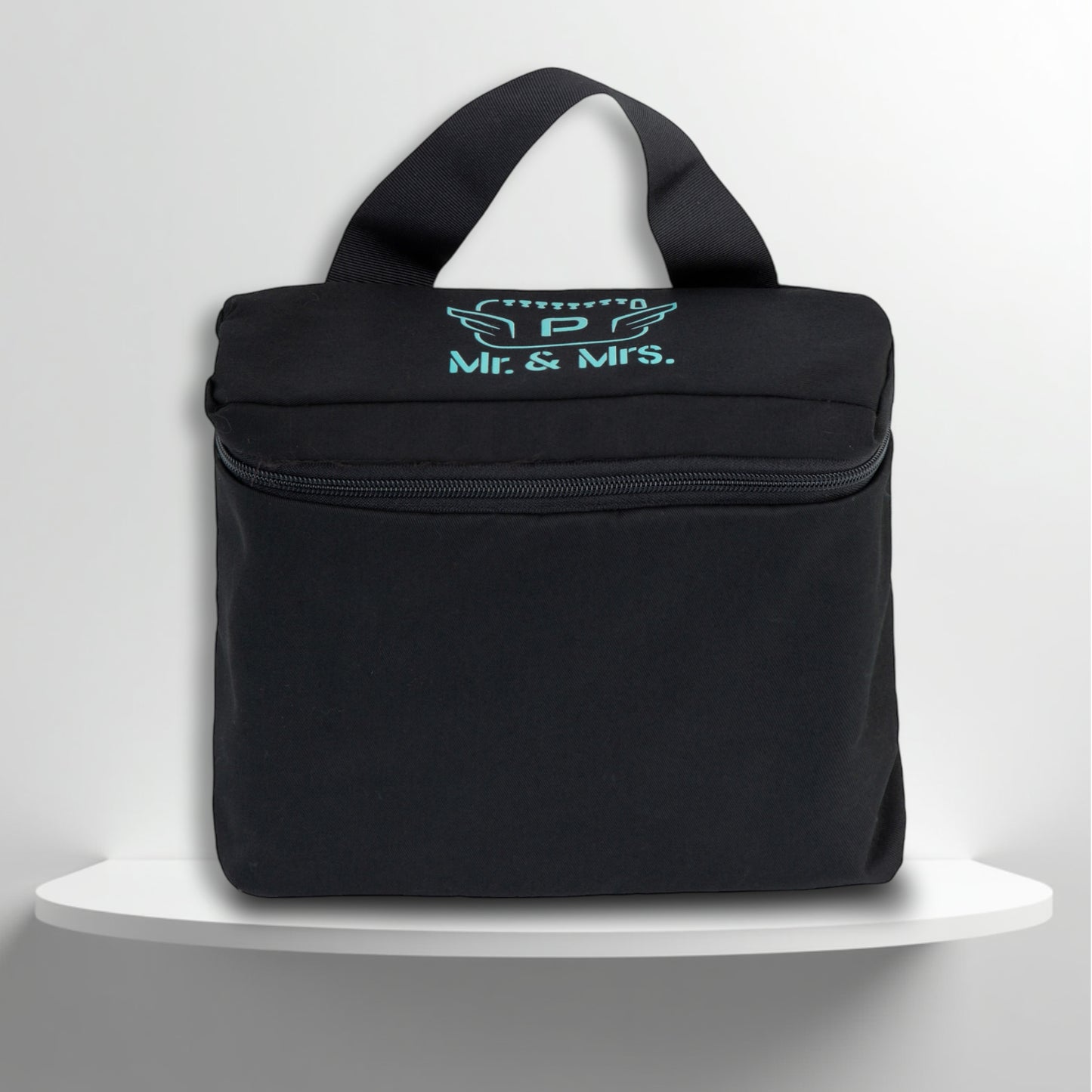 A black cotton travel vanity bag with many Greek travel size personal hygiene products inside for couple