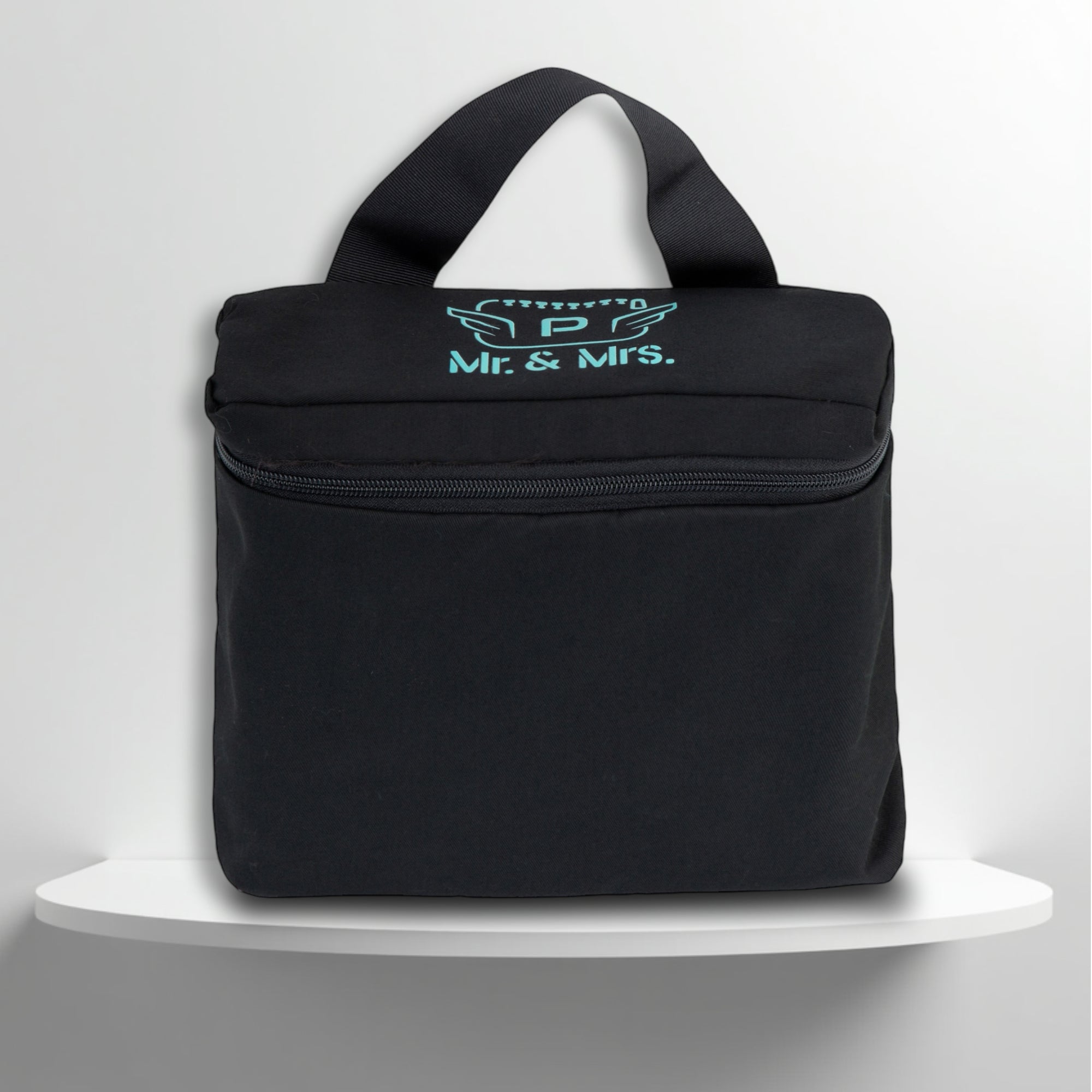 A black cotton travel vanity bag with many Greek travel size personal hygiene products inside for couple
