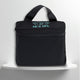 A black cotton travel vanity bag with many Greek travel size personal hygiene products inside for couple