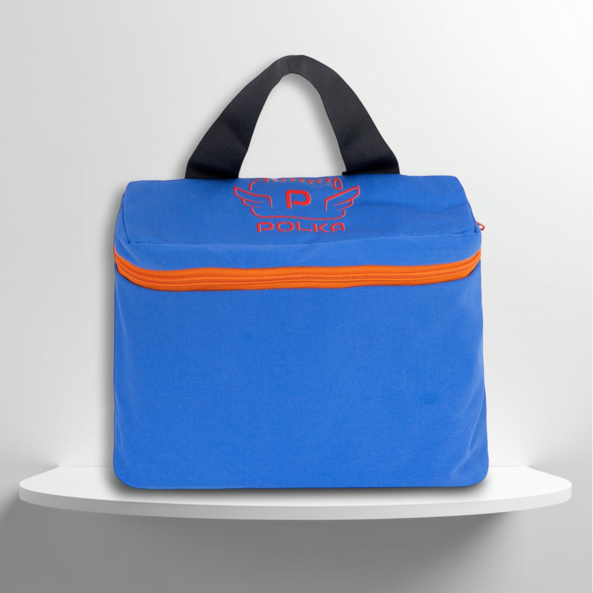 A blue, with orange details, cotton travel vanity bag with many Greek travel size personal hygiene products inside for men
