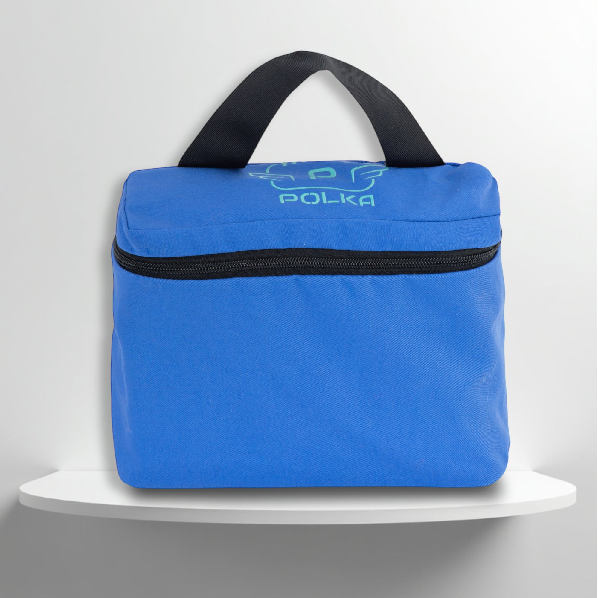 A blue cotton travel vanity bag with many Greek travel size personal hygiene products inside for men