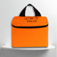 A Fluo orange cotton travel vanity bag with many Greek travel size personal hygiene products inside
