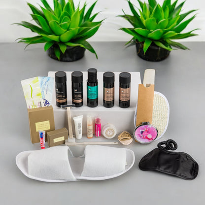 Organic Greek travel size shampoo , conditioner, shower gel, body lotion and many other toiletries that are inside the POLKA women’s travel vanity bag.