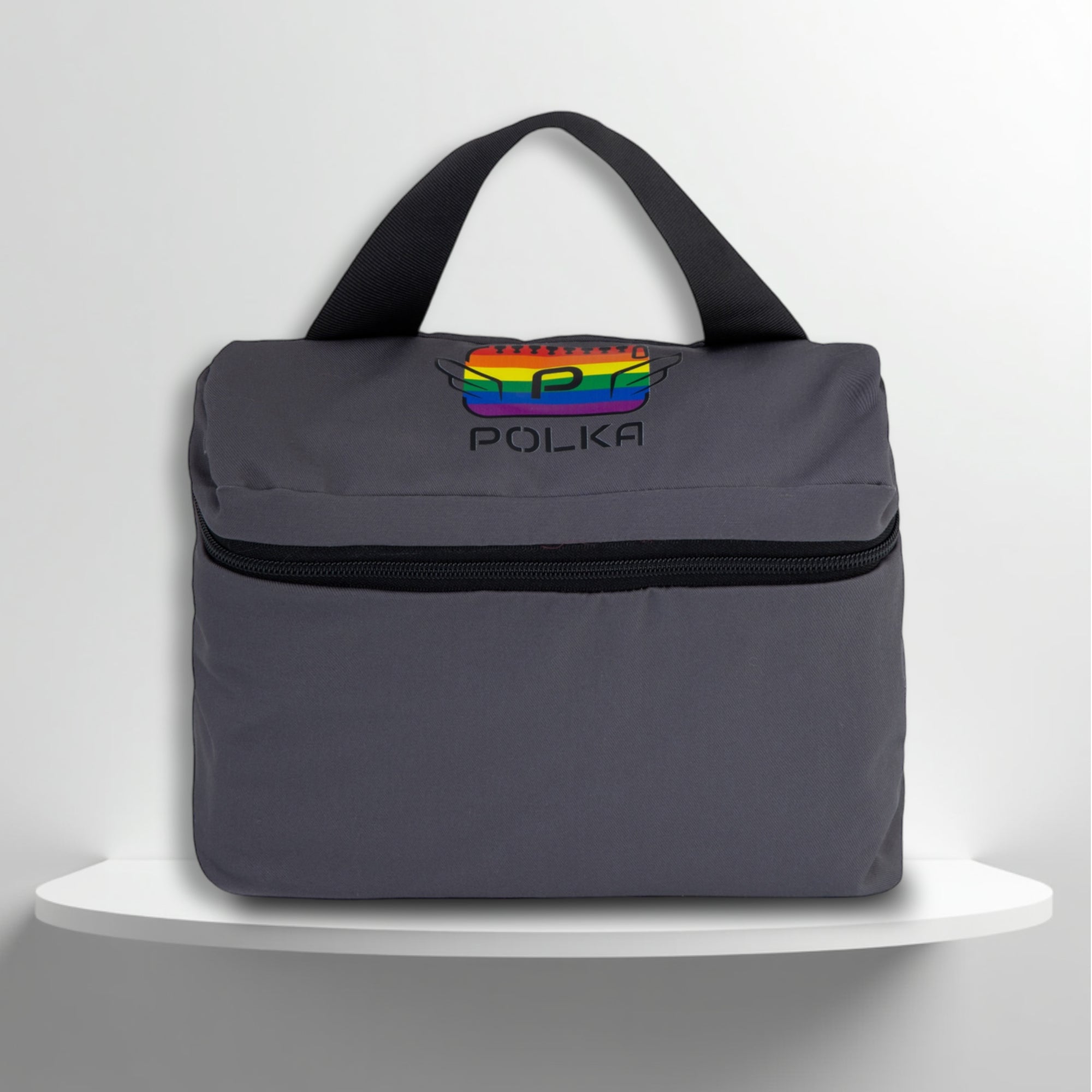 A grey cotton travel vanity bag with many Greek travel size personal hygiene products inside for the LGBTQ+ community 
