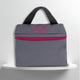 A grey cotton travel vanity bag with many Greek travel size personal hygiene products inside for the LGBTQ+ community