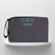 A grey cotton travel vanity bag with many Greek travel size personal hygiene products inside for men