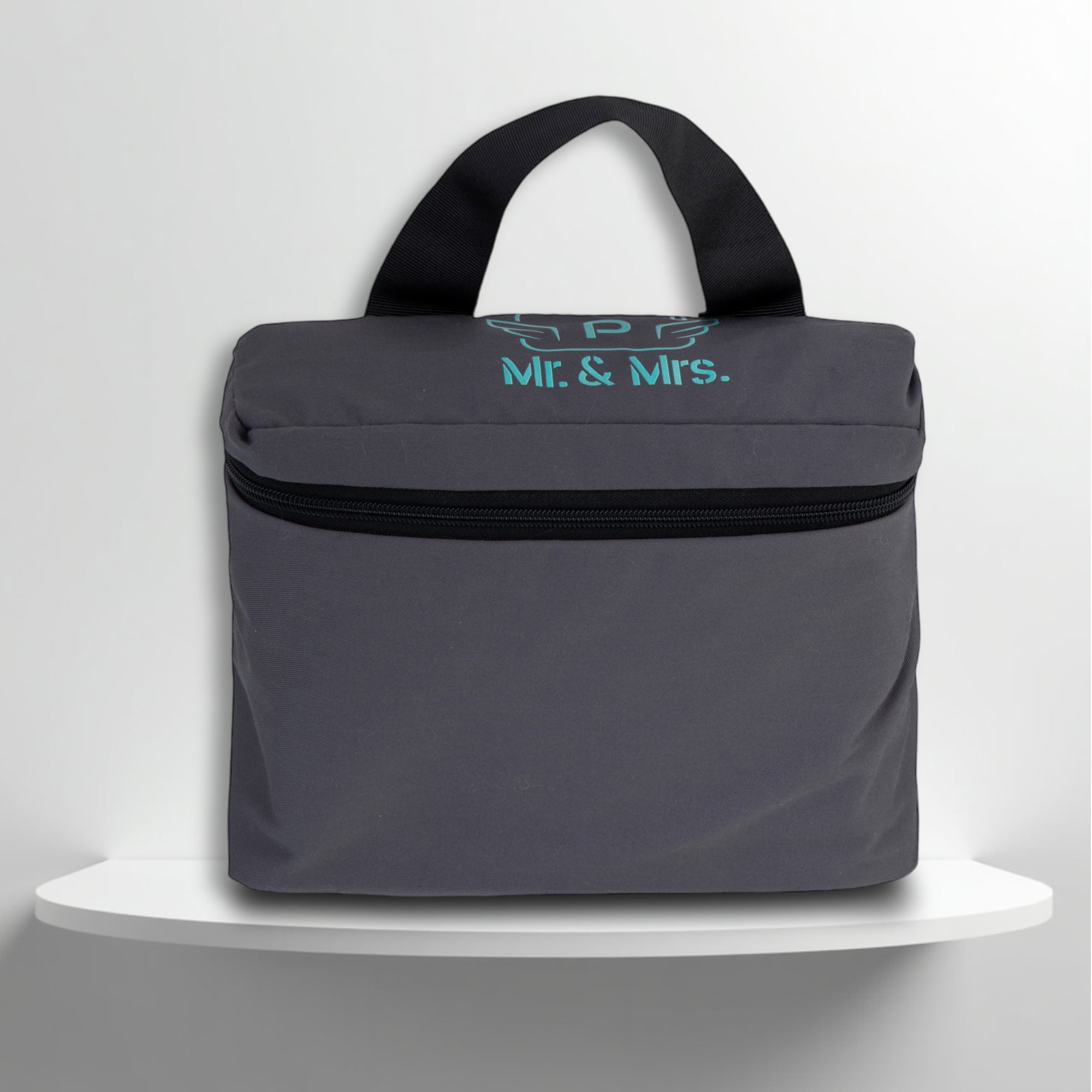A grey cotton travel vanity bag with many Greek travel size personal hygiene products inside for couples
