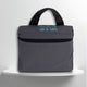 A grey cotton travel vanity bag with many Greek travel size personal hygiene products inside for couples
