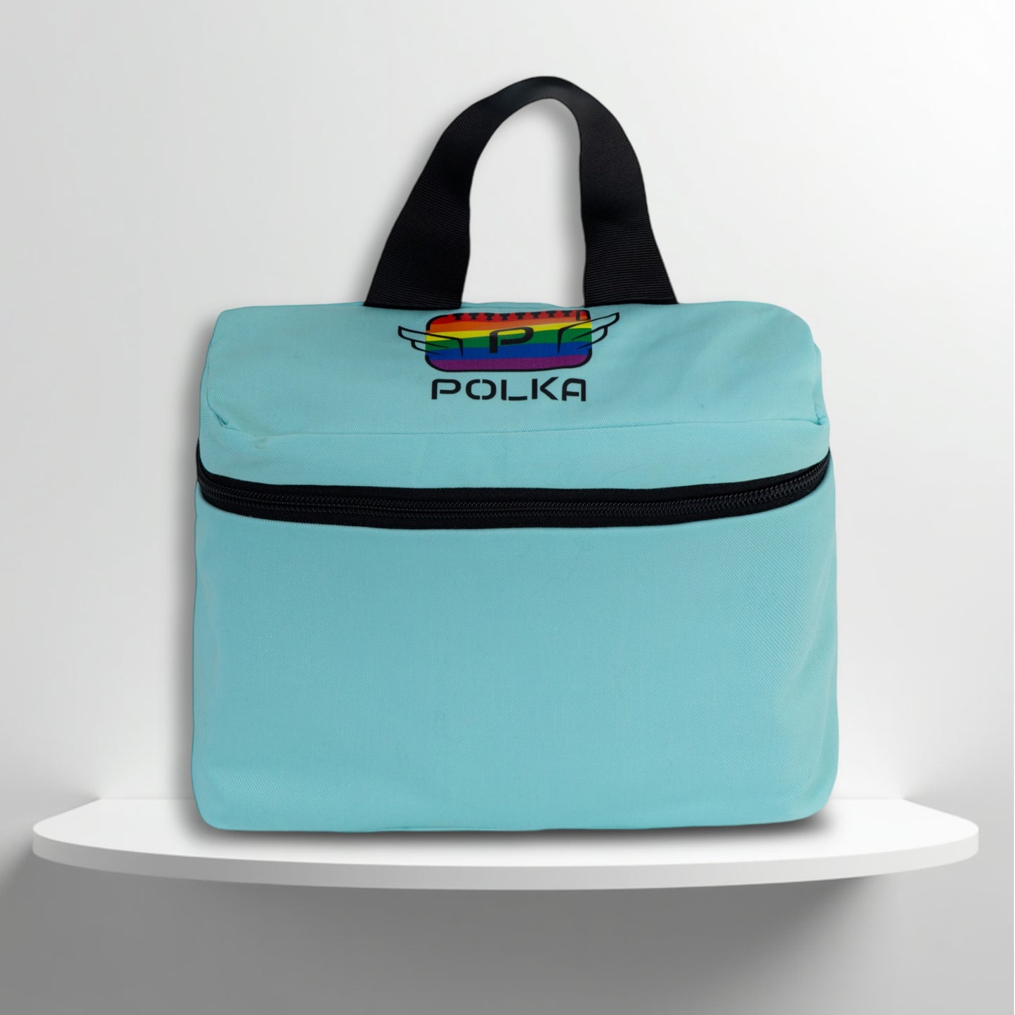 A mint cotton travel vanity bag with many Greek travel size personal hygiene products inside for the LGBTQ+ community 
