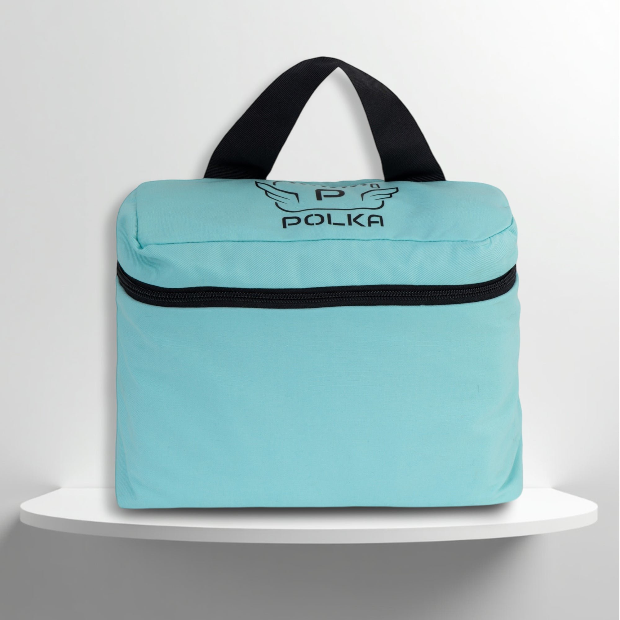 A mint cotton travel vanity bag with many Greek travel size personal hygiene products inside