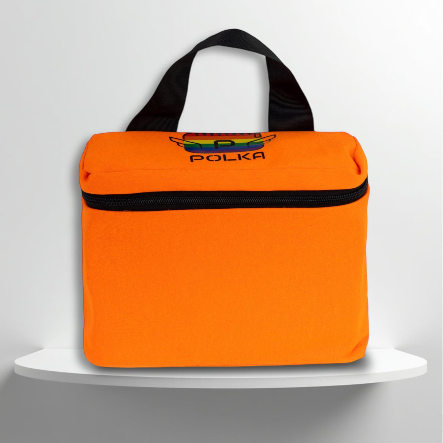 An orange cotton travel vanity bag with many Greek travel size personal hygiene products inside for the LGBTQ+ community 