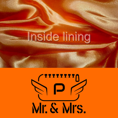 Detail of the orange color of the fabric and black logo with the inside lining of the luxury POLKA vanity bag for couples