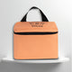 A salmon pink cotton travel vanity bag with many Greek travel size personal hygiene products inside